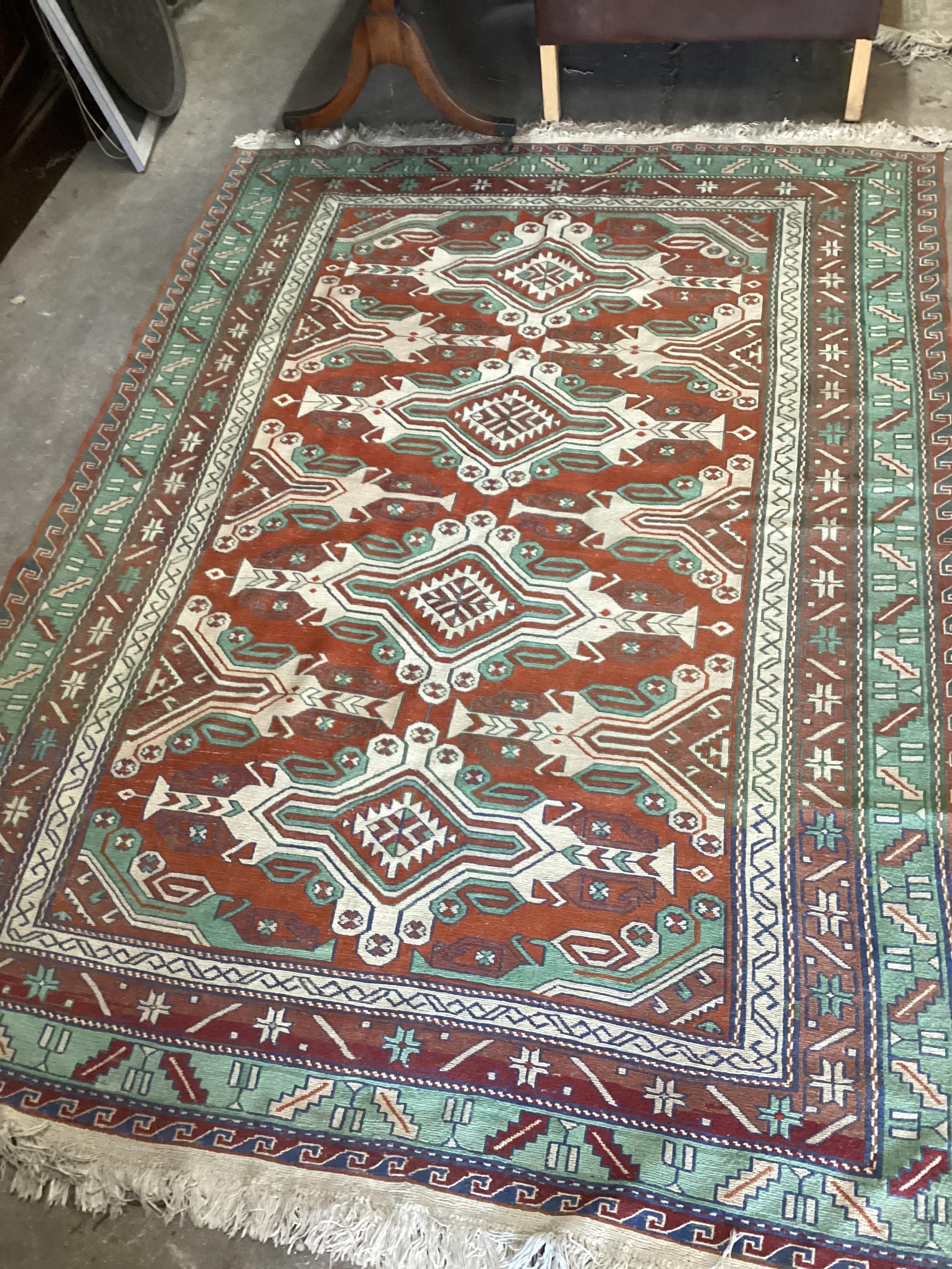 A Caucasian style red ground carpet, 260 x 180cm
